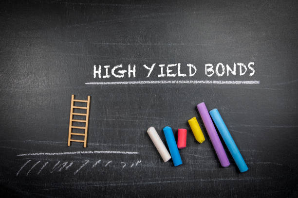 High yield bonds. Text and colored pieces of chalk on a dark board stock photo