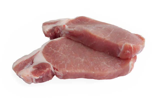 istock Sliced raw pork meat isolated on white background with clipping path. 1474743601