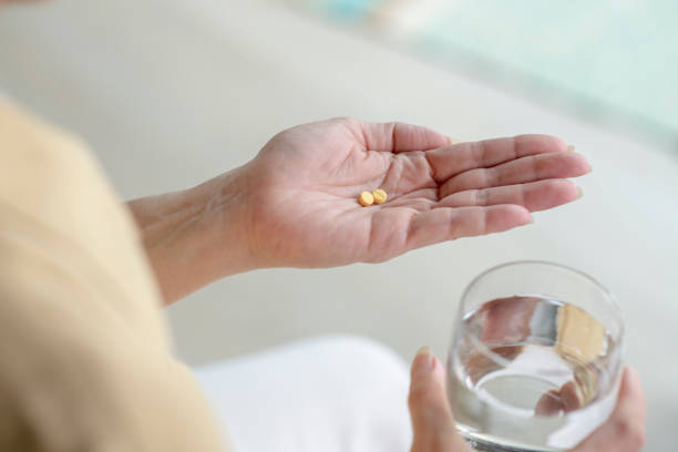 istock Woman holding pills in hand 1474743694
