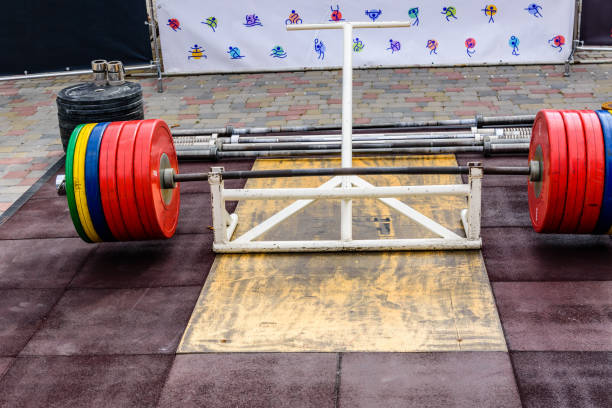 istock Heavy barbell on a platform in street gym 1474745440