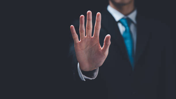 istock man hand stop sign, warning concept, refusal, caution, symbolic communication, preventing subsequent problems,Help Prevent Piracy, Stop Violence,Warning gestures to stop and check safety 1474746596