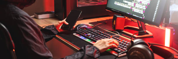 istock Dangerous Hooded Hacker typing bad data into computer online system and spreading to global stolen personal information. Cyber security concept 1474746798