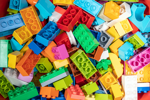 Toy plastic bricks constructor. Full frame abstract background