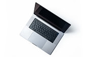 Modern laptop with blank black screen isolated on white background. High angle view.