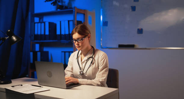 istock Doctors work at the office at night on a laptop pc. 1474747847