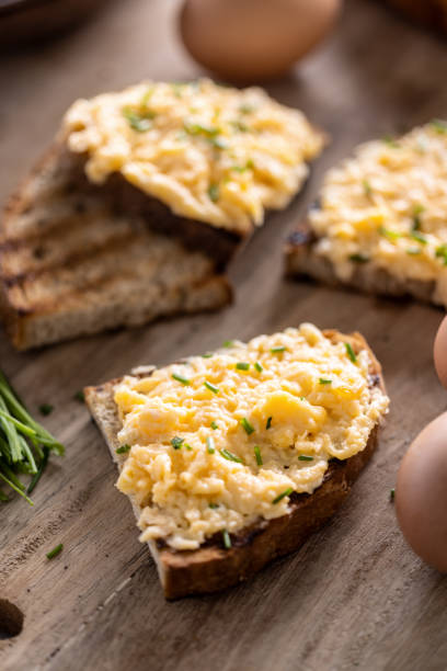 istock Fresh and crunchy bread toasts with silky smooth scrambled eggs and fresh chopped chive sprinke. 1474751498