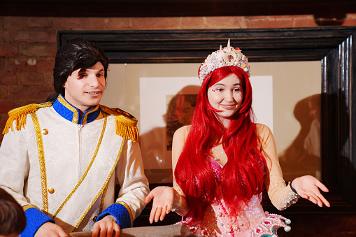 actors in costumes of a prince and a mermaid at a children's party. entertainment for children.
