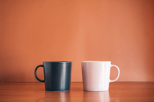 istock Black and Pink ceramic coffee cup on wood desk with brown background. 1474752463