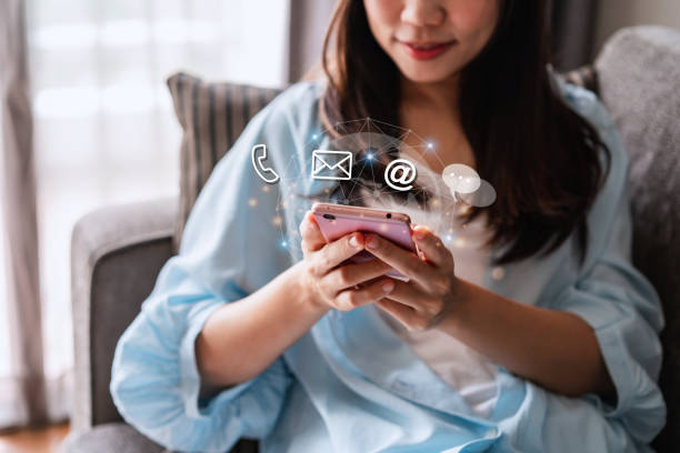 istock Young woman using phone with email and chat message icon, Customer support hotline Contact us concept 1474752974