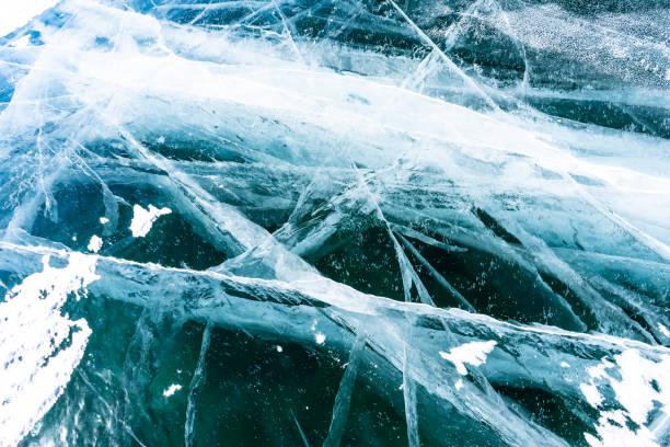 istock Cracked ice on a frozen lake, view from the top. Mouse background. 1474753873