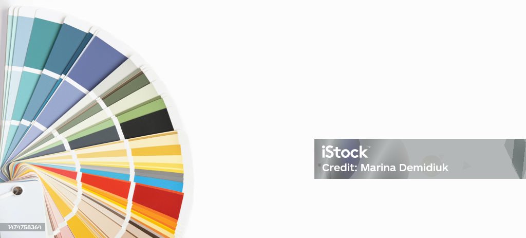 Color guide close up. Assortment of colors for design. Colors palette fan on a white concrete wall background. Graphic designer chooses colors from the color palette guide. Coloured swatches catalogue Abstract Stock Photo