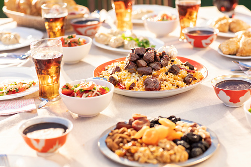 Uzbek National Dish of Pilaf and Samsa on Dinner Table