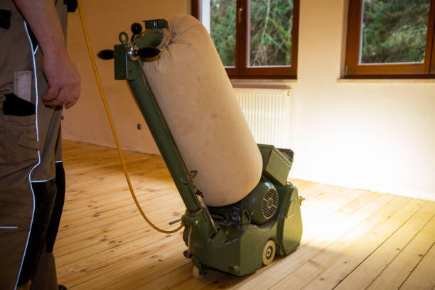 istock Craftsman professionally sanding a plank floor 1474761903