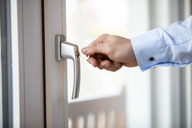 istock Closeup of a hand locking balcony door 1474762626