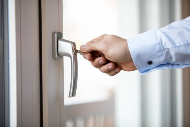 istock Closeup of a hand locking balcony door 1474762656