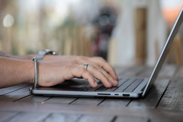 istock Closeup of a mans hand working on a laptop 1474762679