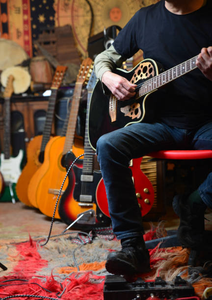 istock Young man plays electric guitar 1474763386