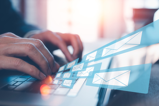 Email concept, businessman using computer laptop on table in office blurred background