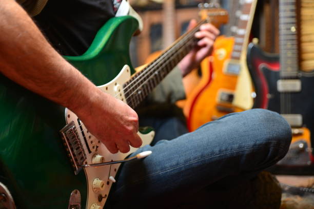 istock Young man plays electric guitar 1474764812