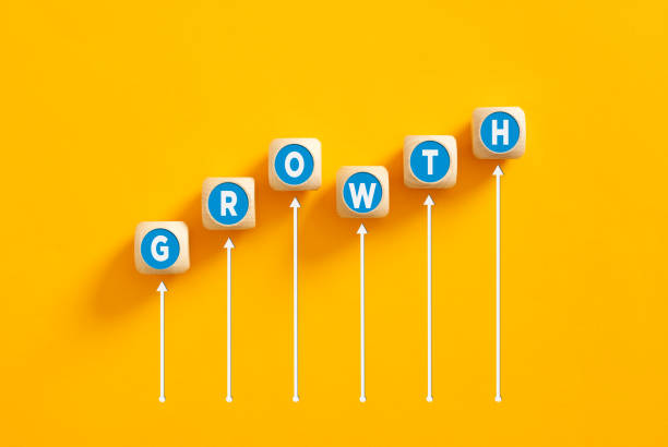 istock The word growth on wooden cubes with an increasing graph. 1474766292