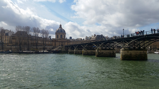 view of the famous pont des arts (lovers' bridge) which spans the seine river in Paris