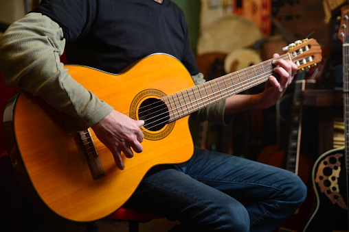 Acoustic guitar played by a men