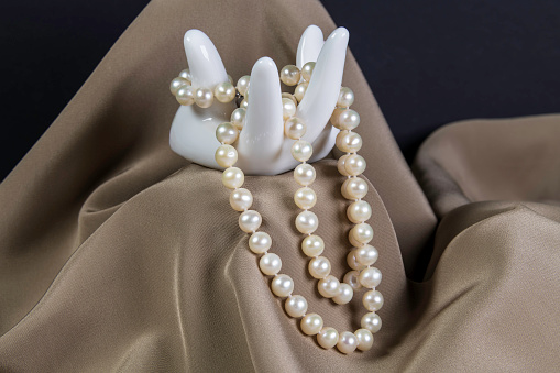 White Porcelaine Hand Holding Necklace Made With White Pearls