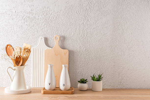 istock modern kitchen background with a copy space on a gray concrete wall. cutting boards, a jug with wooden tools. 1474769790