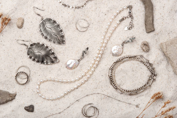 istock Beautiful Silver and Pearl Jewelry on white sand. 1474770774