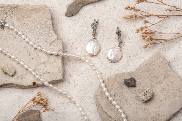 istock Beautiful Pearl Jewelry on white sand. 1474770787