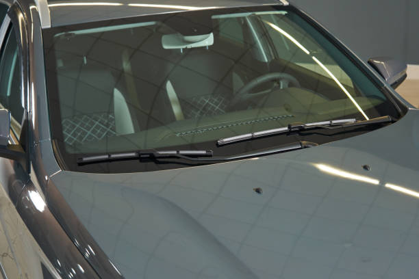 istock clean transparent windshield of a gray car. windshield wipers, front panel, steering wheel, seats are visible 1474770828