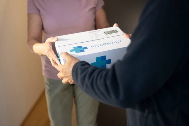 istock Delivery person delivering medicine 1474770948