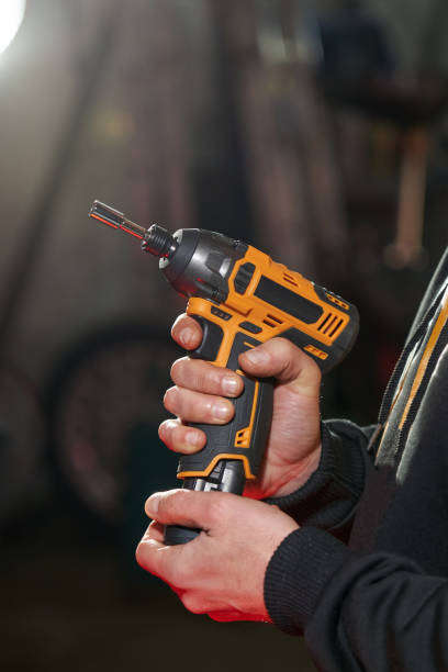 istock men's hands put in take out a replaceable battery from an electric wrench 1474771066
