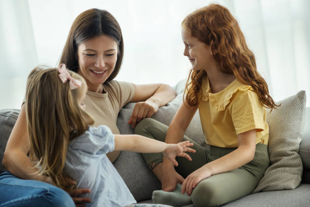 istock Mother and daughters having fun at home. 1474771089