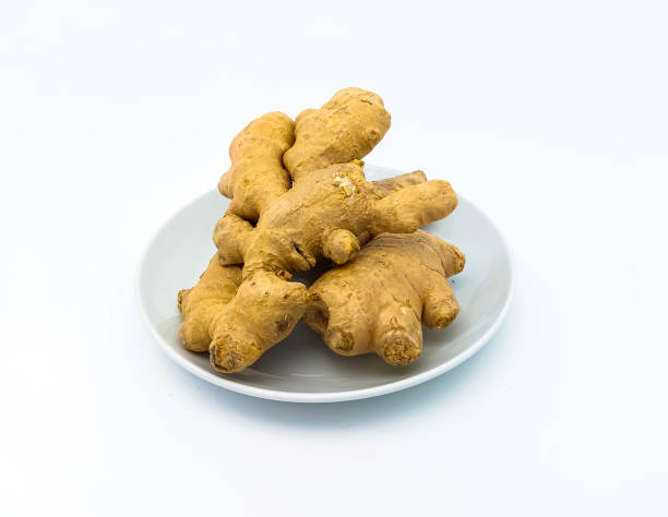 istock Fresh ginger rhizome on a white plate, isolated on white background. 1474771190