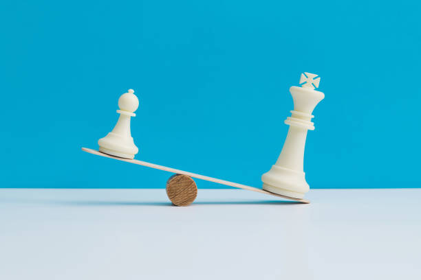 istock Seesaw with king and pawn chess pieces 1474771227