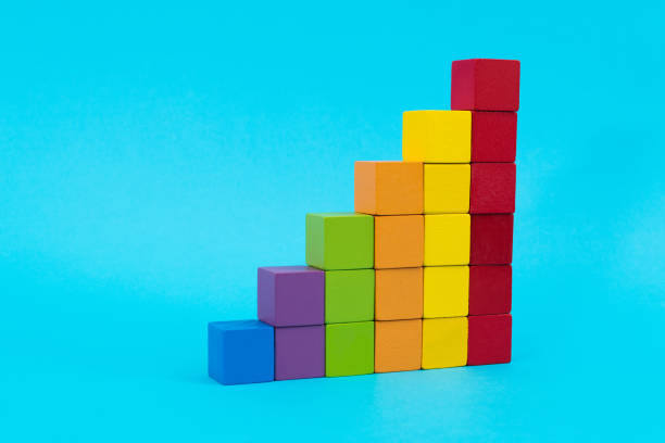 istock Wooden toy blocks stairs on blue background 1474771267