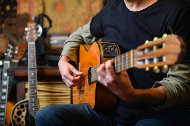 istock Young man plays Acoustic guitar 1474771310