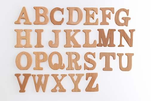 Wooden alphabet blocks on white background.