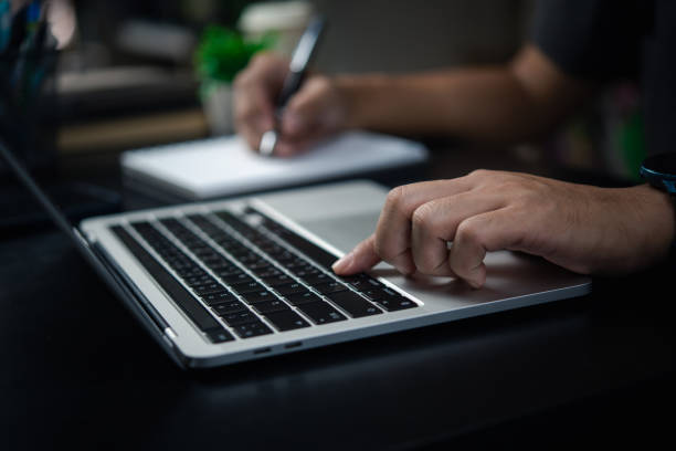 istock Businessman working on laptop computer in office or student browsing information, social networks digital technology. 1474773264