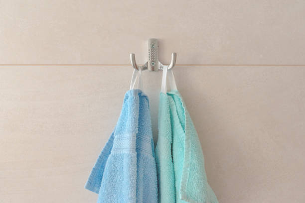 istock Blue and turquoise towels hanging on the bathroom wall 1474776619