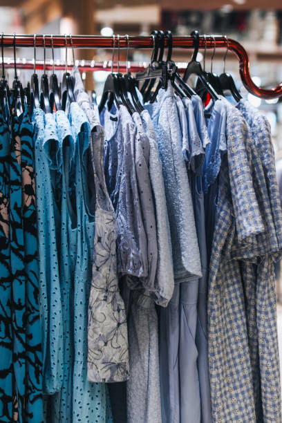 istock Blue women's clothes dresses hanging on a hanger in a row. 1474778131