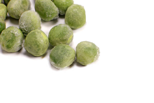istock Frozen green pea macro closeup isolated on white 1474778389