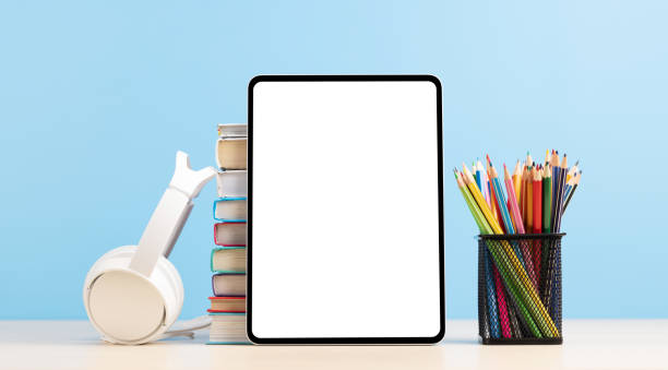 istock Tablet with colorful pencils and stack of books 1474778396