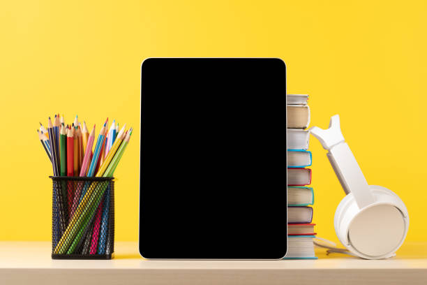 istock Tablet with colorful pencils and stack of books 1474778436