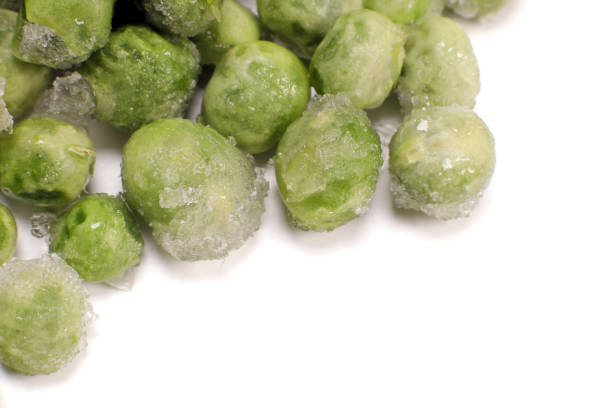 istock Frozen green pea macro closeup isolated on white 1474778563