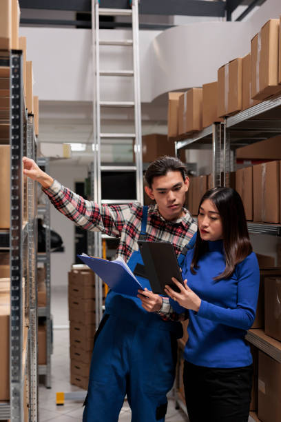 istock Warehouse employees managing inventory tracking with goods checklist 1474780007