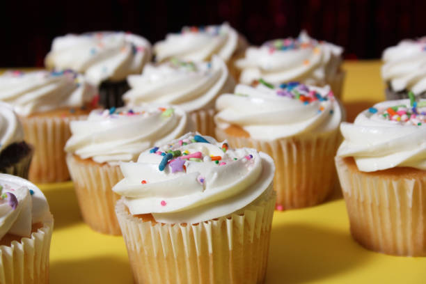 istock Cupcakes on Table at Party on Yellow Table 1474780401