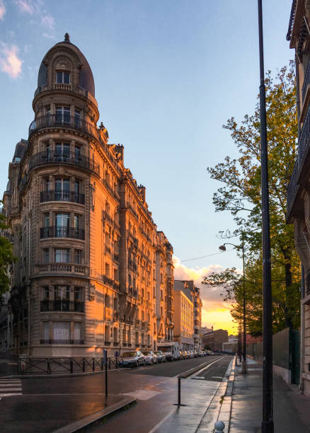 Rue Manin street view with evening sun-painted buildings and beautiful sunset view located in the 19th arrondissement of Paris, France.