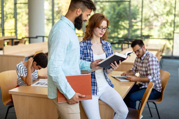 istock Happy group of students studying and working together in a college library 1474781557